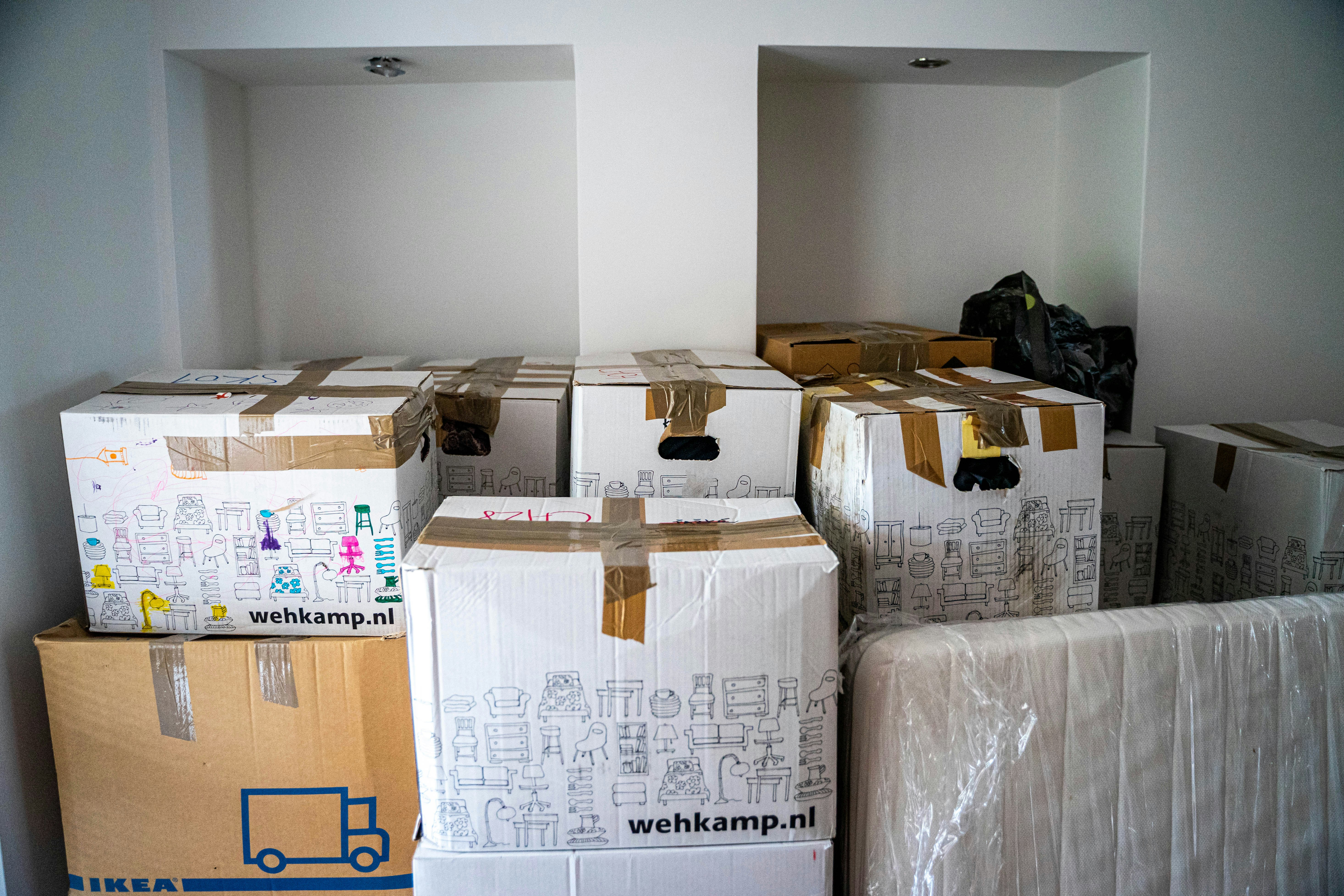 Older couple packing boxes for downsizing into a smaller property
